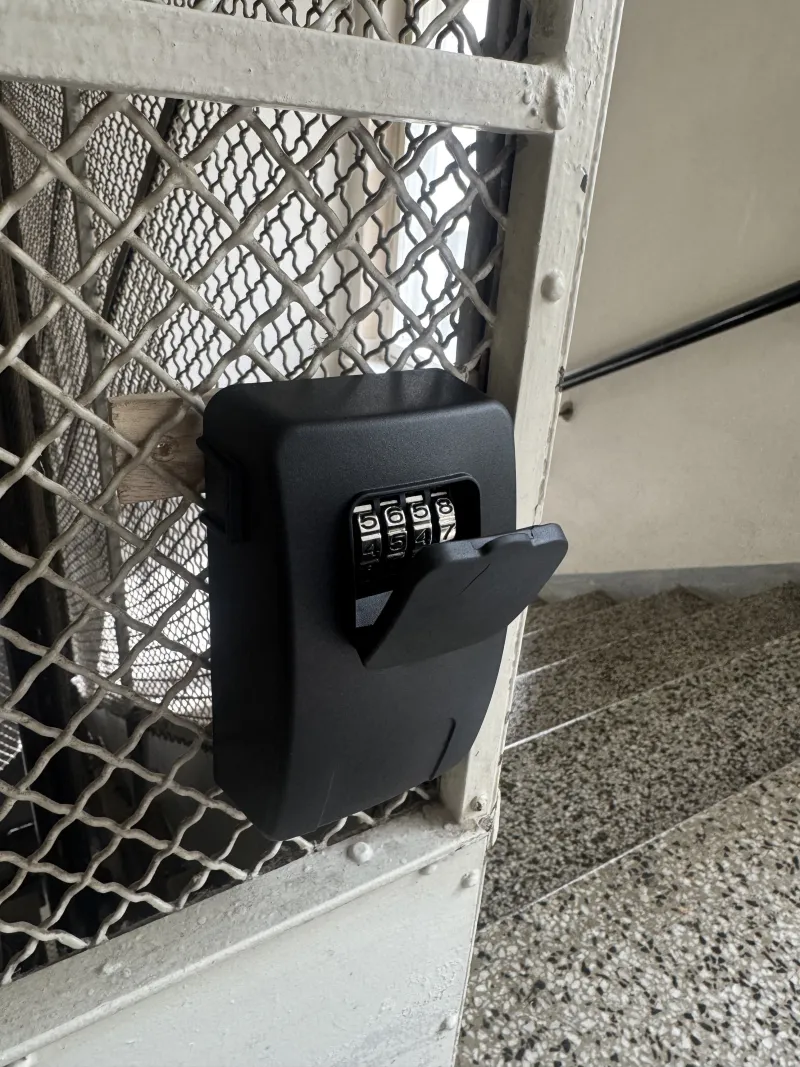 The lock box with its cover slid open, showing the four-digit dial